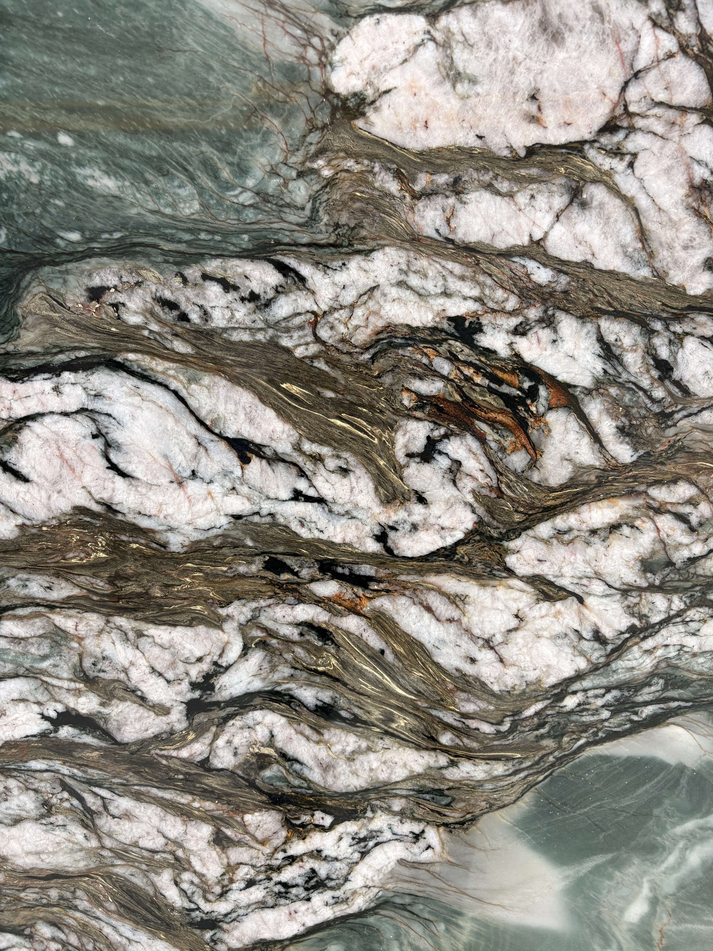 Tropical Green quartzite detail, fractured white quartz and dark mineral cutting through green movement