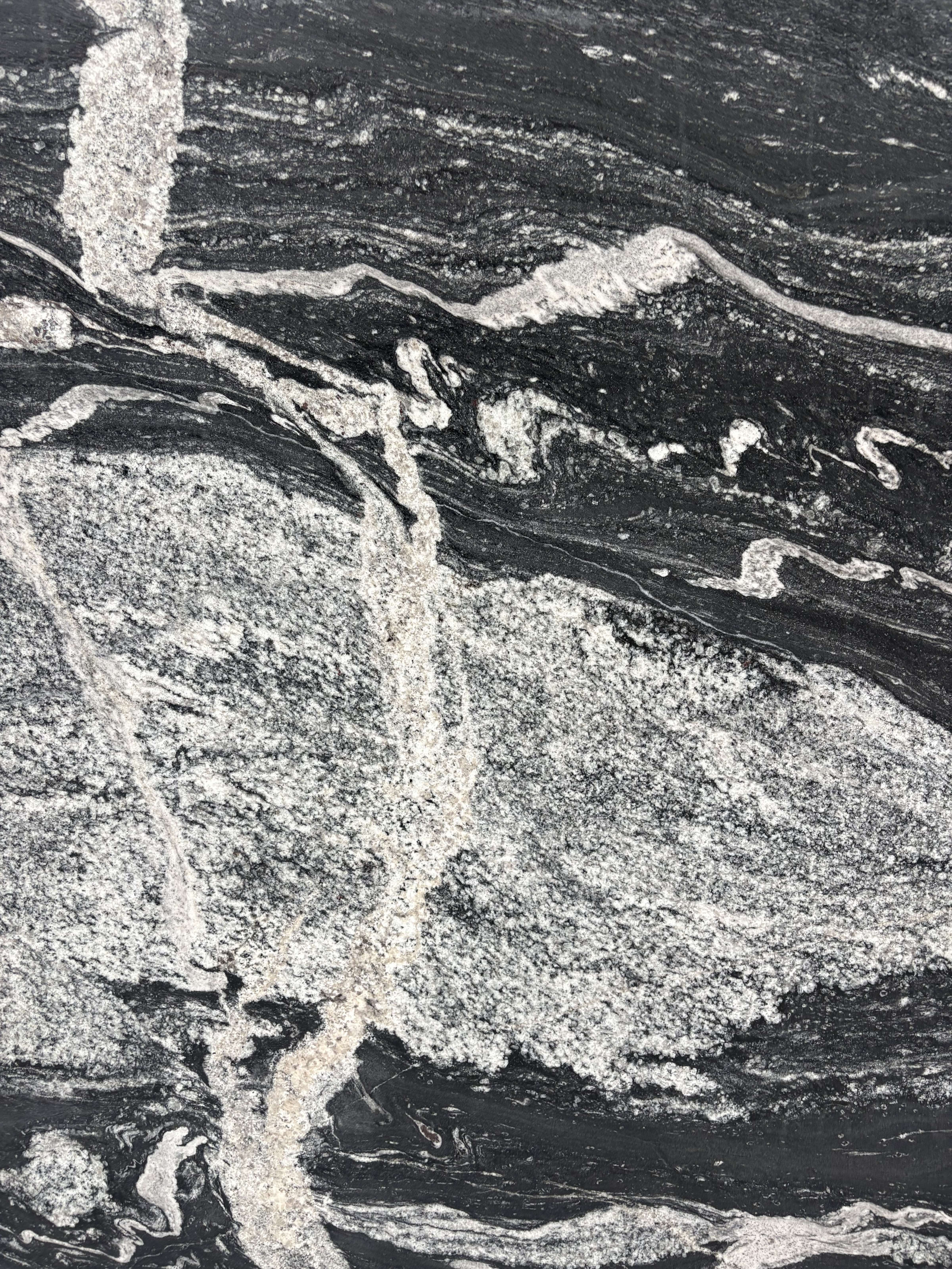 Black Storm granite detail, black ground with a broad band of white quartz breaking across it