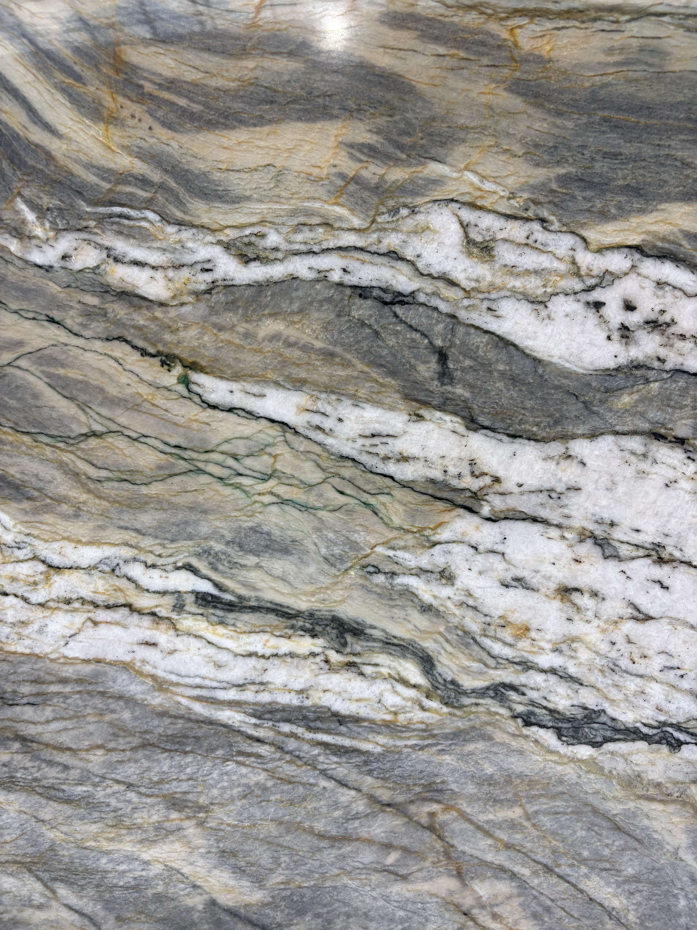 Van Gogh quartzite detail, white quartz and gold banding folding through smoke grey and green