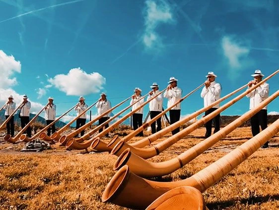 Swiss People playing the alphorn