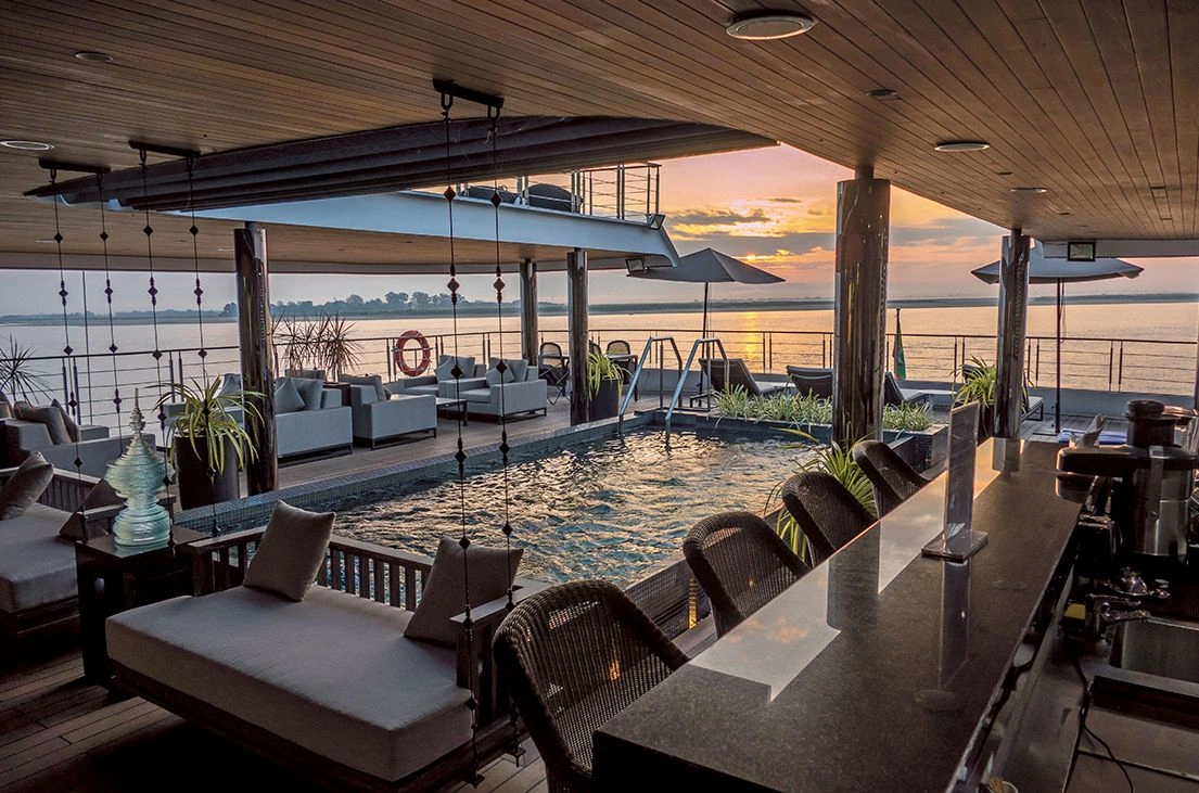 Scenic Aura vitality pool and lounge at sunset overlooking a tranquil river