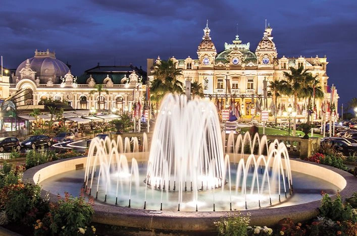 Illuminated fountain outside the Casino de Monte-Carlo in Monaco at night