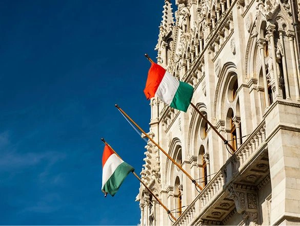 The flag of Hungary hanging from the Hungarian Parliament Building