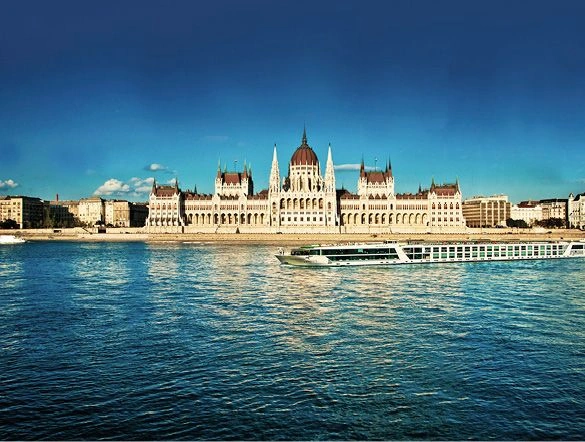Luxury river ship sailing along the Danube River in front of the Hungarian Parliament Building 