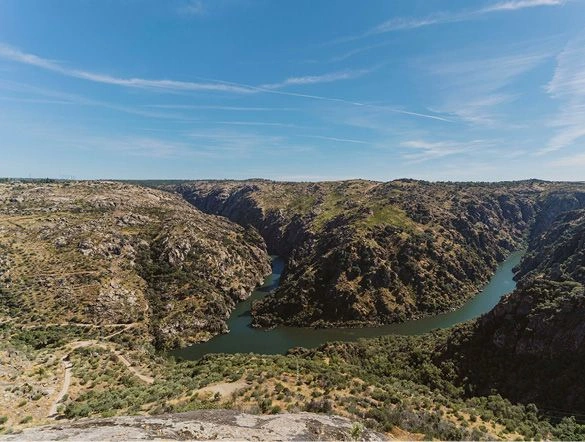 An aerial shot of Douro International Natural Park in Portugal. The river and valley sit among the mountains.