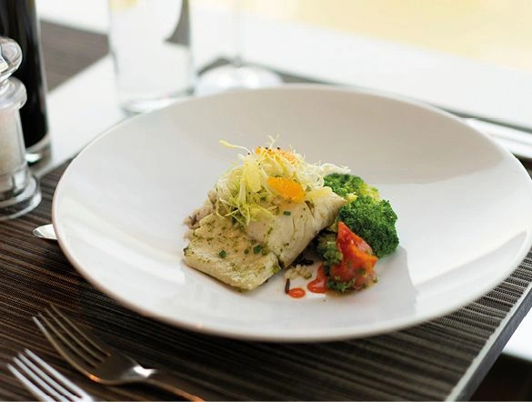 Delicious meal of fish and vegetables and a crisp glass of white wine