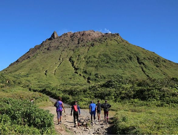 A group of people hiking around La Soufriere volcano in Guadeloupe