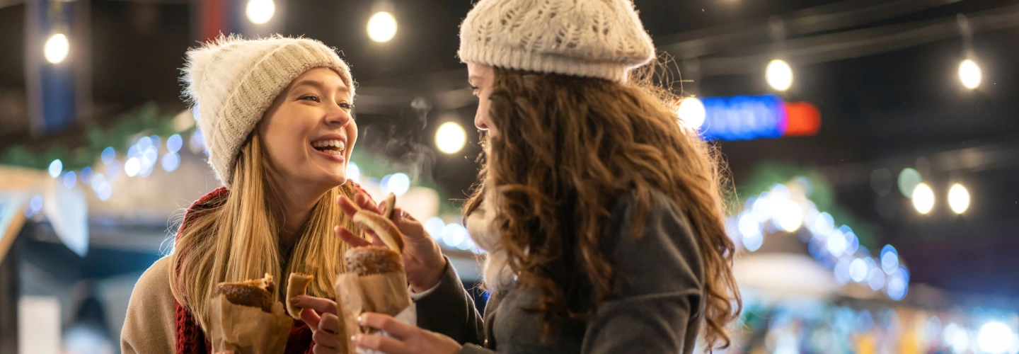 Two female friends enjoying a European Christmas market