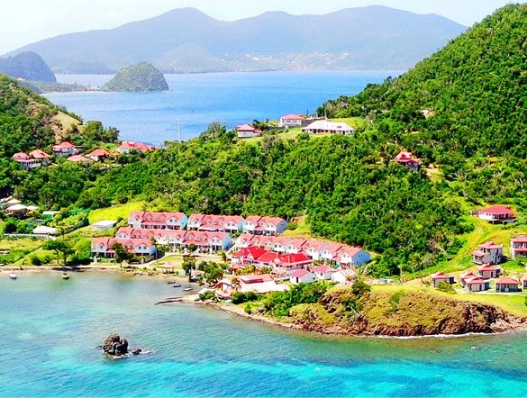 Clear blue waters and lush green mountains in Terre de Haut Guadeloupe