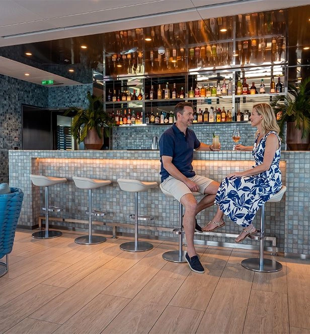 Two guests share drinks at Emerald Kaia’s Sky Bar