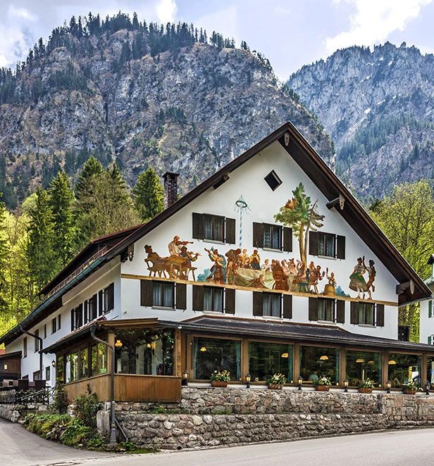 Frescoed Alpine house beneath rugged mountains in Oberammergau
