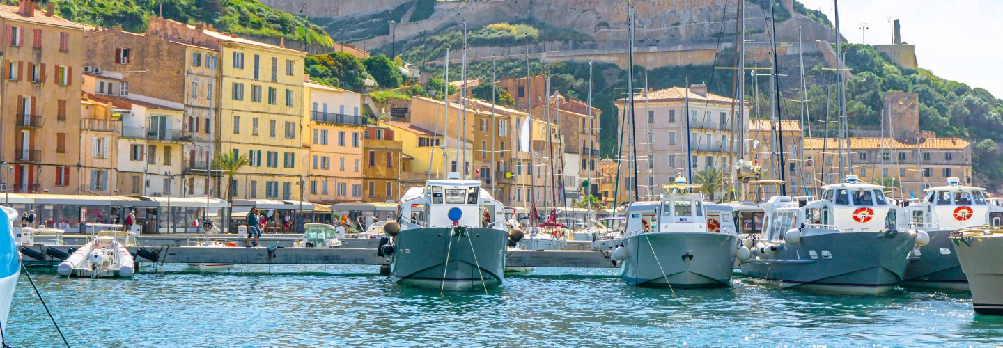 Boats in Bonifacio harbour beneath the Corsican citadel