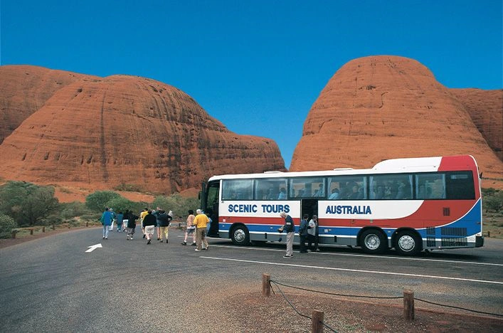 Guests leaving a coach at Kata Tjuta in central Australia