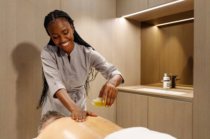 Spa therapist giving a back massage to a guest