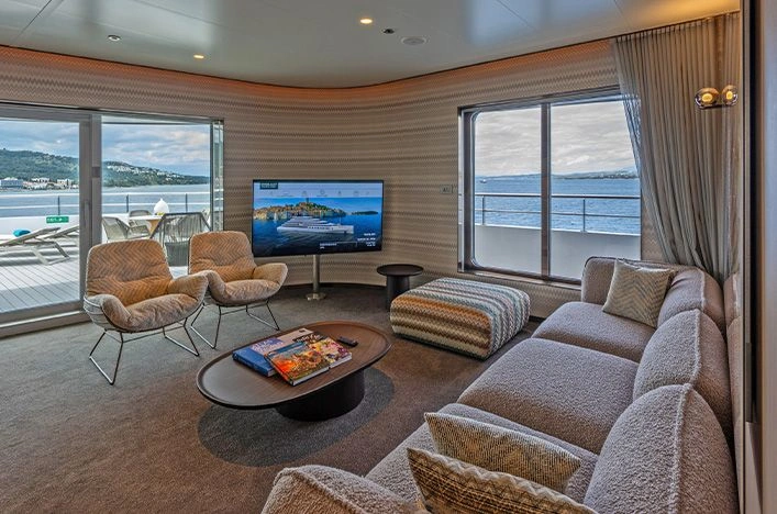 Emerald Kaia Owner’s Suite lounge with private balcony and sea views
