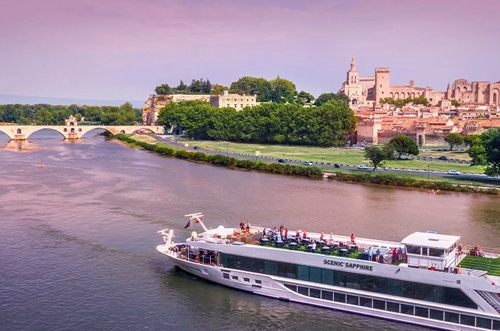 Scenic Sapphire cruising past Avignon’s medieval bridge and Palais des Papes