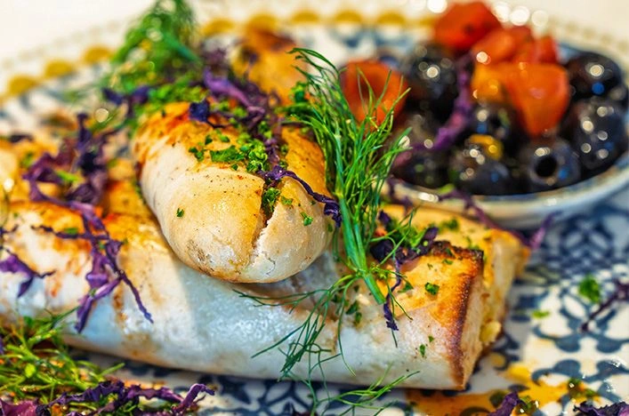 Seared white fish with herbs, berries and roasted vegetables