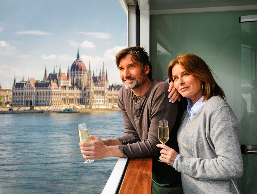 couple in front of the budapest parliament building