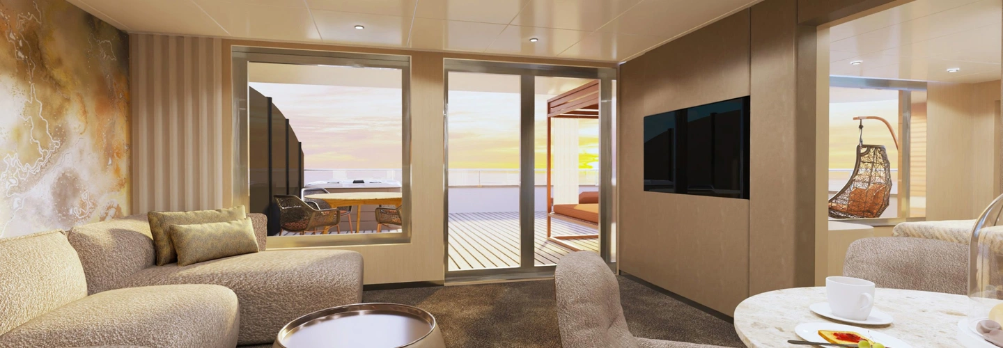 Spacious Scenic suite lounge opening onto a private deck with daybed at sunset