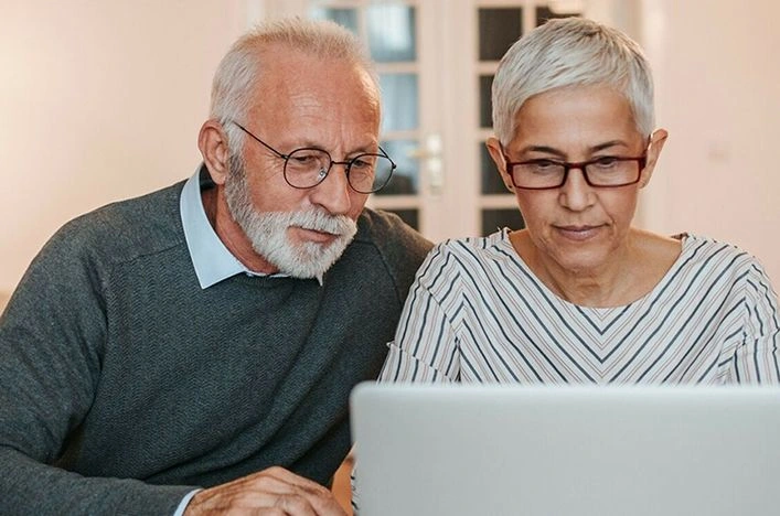 Couple sitting with laptop