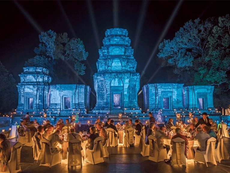 Guests having dinner in front of the illuminated Angkor Wat Temple, Siem Reap 