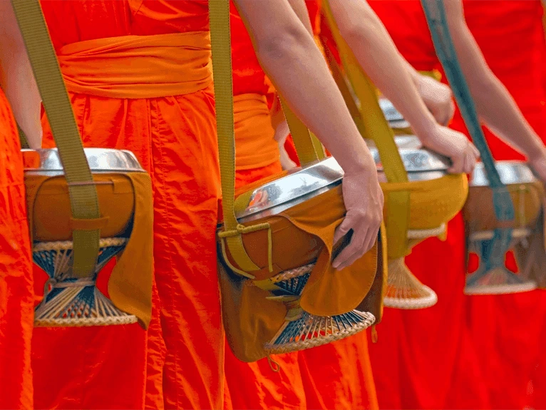 Monks carrying their alms bowl in