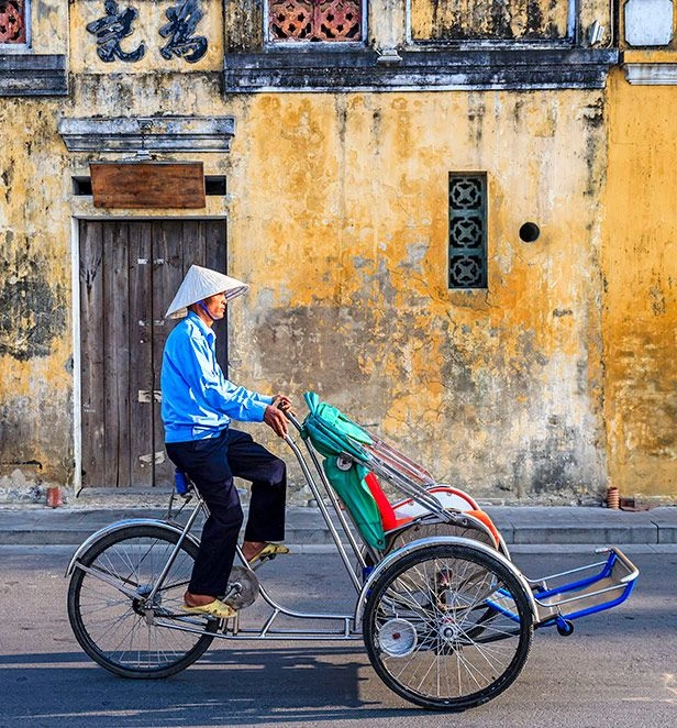 Local riding a Cyclo in the streets of Hội An, Vietnam