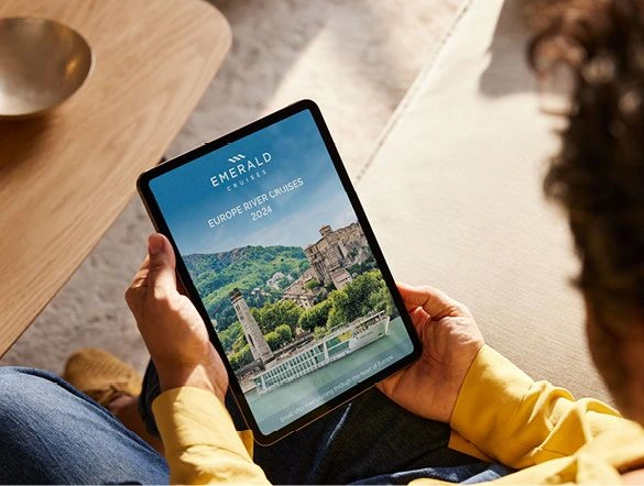 A person reads Emerald Cruise Europe River Cruises 2024 brochure on their tablet