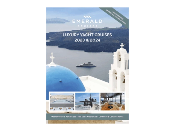 A luxury yacht cruise brochure cover, featuring a yacht sailing the seas of Santorini in front of the blue-domed church