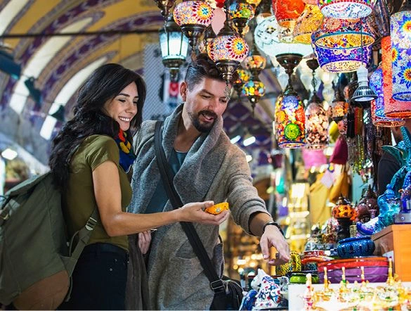 People wandering through the many stalls at the Grand Bazaar market in Istanbul soaking up the vibrant atmosphere