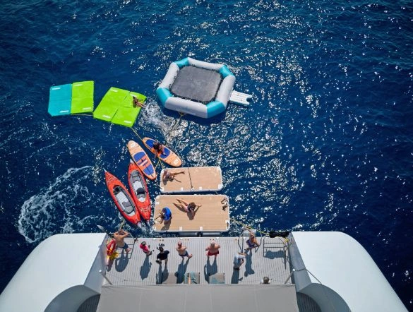 The back of an Emerald Cruises yacht from birds eye view with toys in the water