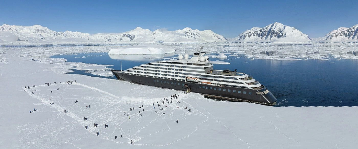 Luxury ocean cruising ship docked next to the ice in Antarctica