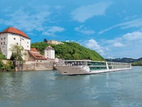 Emerald Sun can be seen sailing along. The sky is blue and a few Spring clouds can be seen.