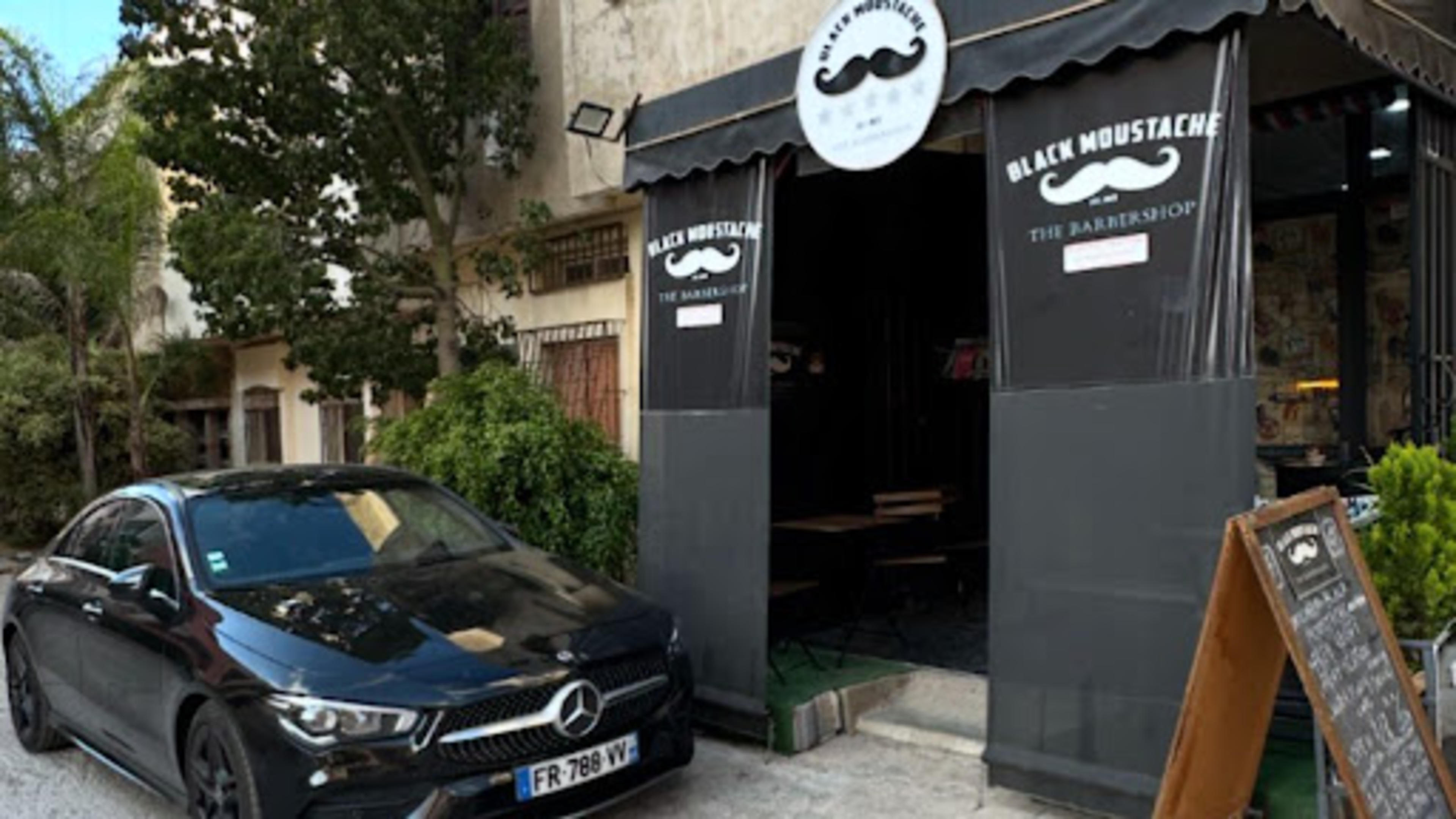 Black Moustache The Barber Shop - logo