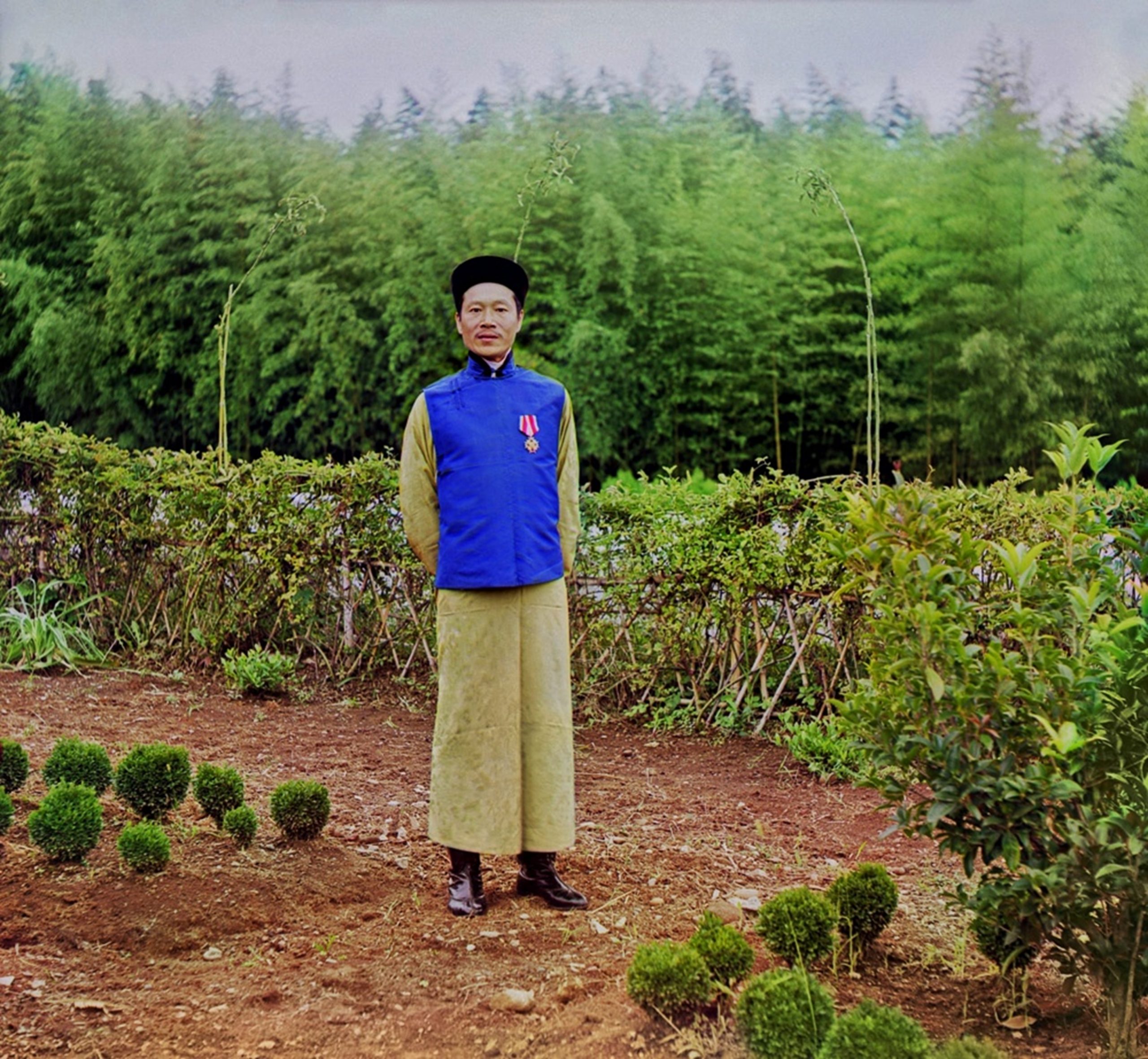 мастер Лао Джон Джау стоит среди плантаций
