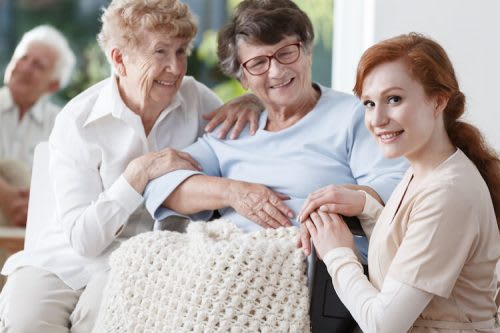 Nurse takes care of elderly patient at a nursing home.