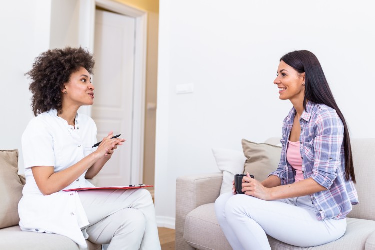 A counselor meets with a smiling client.