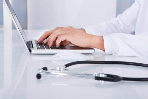 medical professional working on laptop
