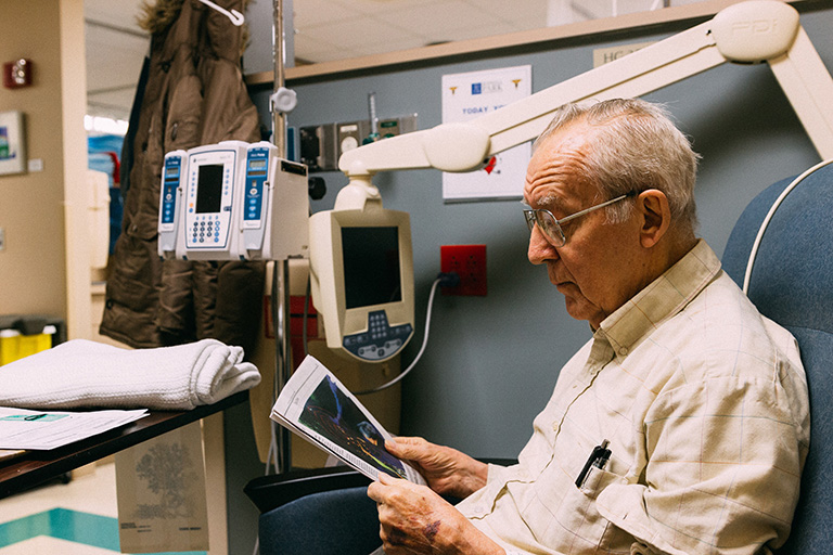 Elderly man looking at his ultrasound findings at the doctors office