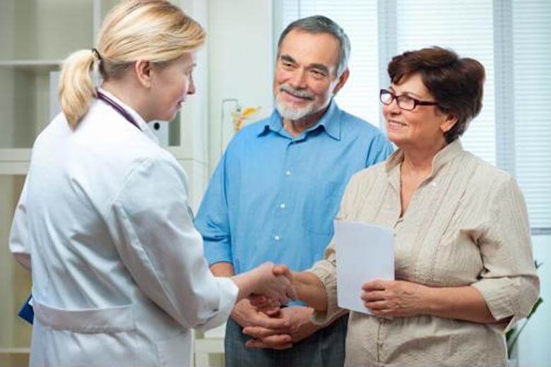 A DNP-prepared nurse meets with a patient and their spouse.