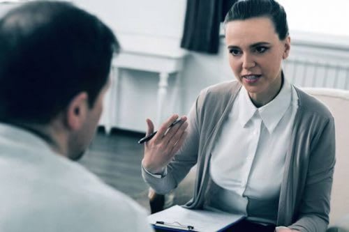 A substance abuse counselor speaks with a client.