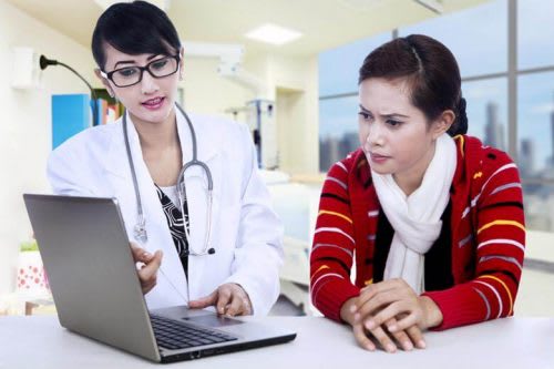 Family nurse practitioner going over data with young patient