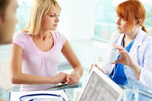 Nurse practitioner talking with patient.