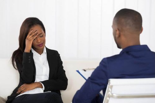 Distressed client talking to counselor.