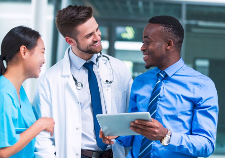 Nursing professionals review data on a tablet.
