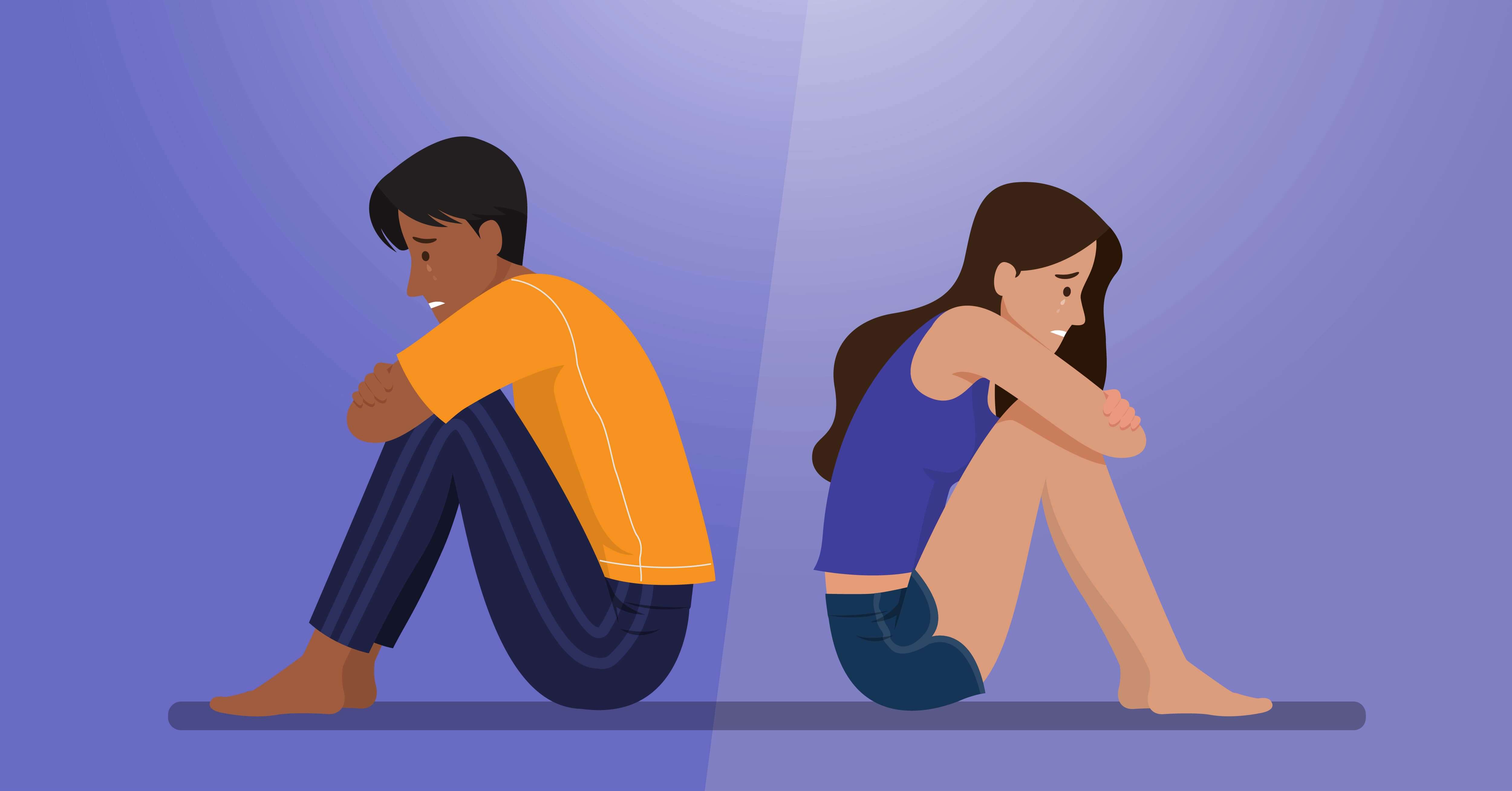 Two crying people sitting back to back.