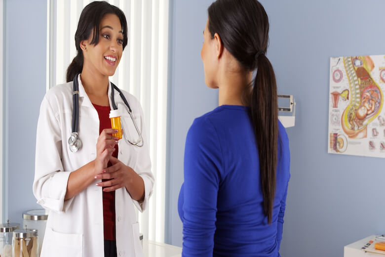 Family nurse practitioner talking to a patient about medication.