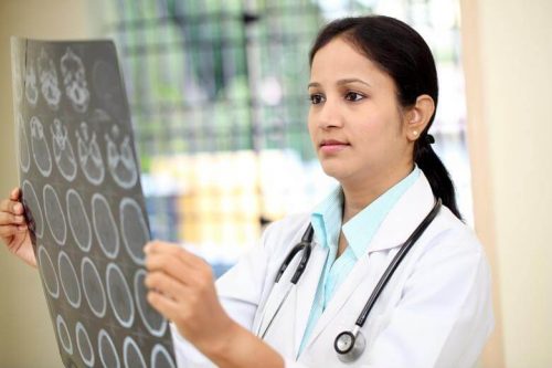Nurse practitioner looking at X-rays.