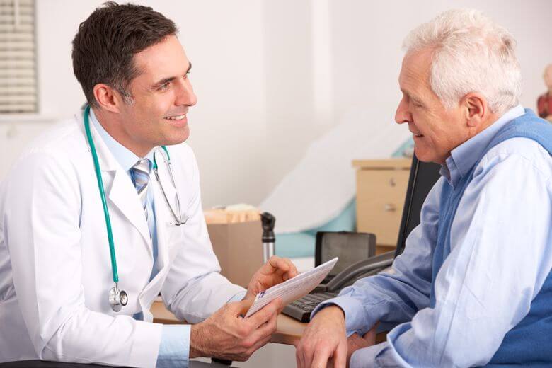 An FNP speaks with a senior patient.