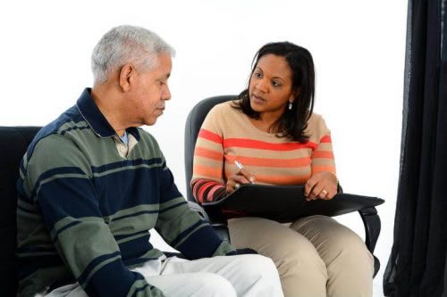 Counselor taking notes while with client.